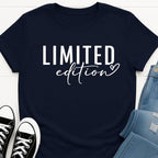 Navy blue Slogan t-shirt with 'LIMITED edition' text, paired with black sneakers and denim shorts on a white background.
